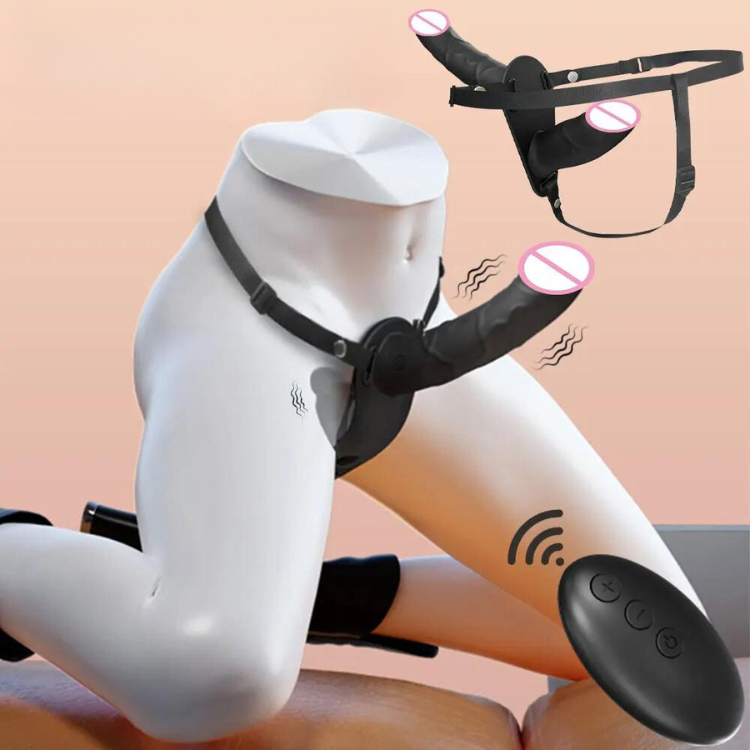 White mannequin wearing a black vibrating strap-on harness with a wireless remote; spare harness above