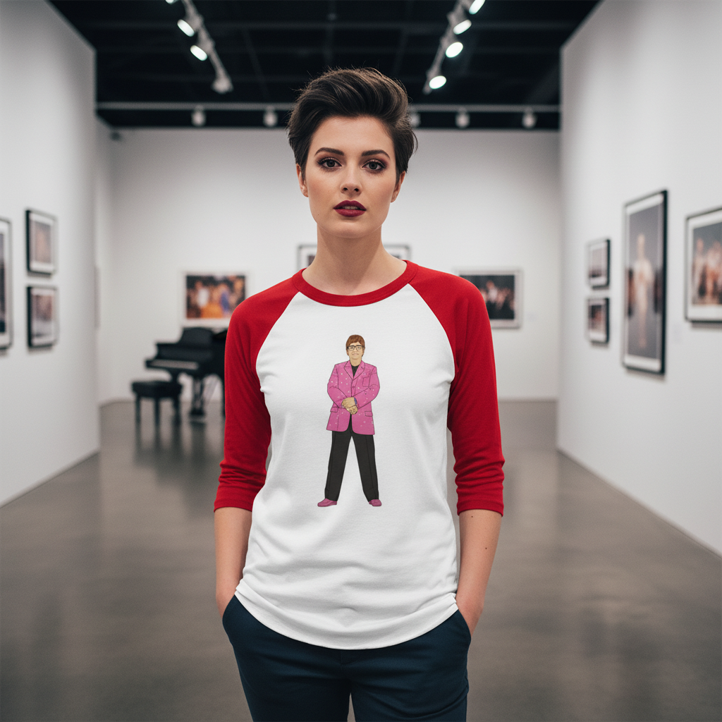 Elton John 3/4 sleeve raglan shirt with a cartoon in a pink blazer, worn by a femme with short dark hair in an art gallery.