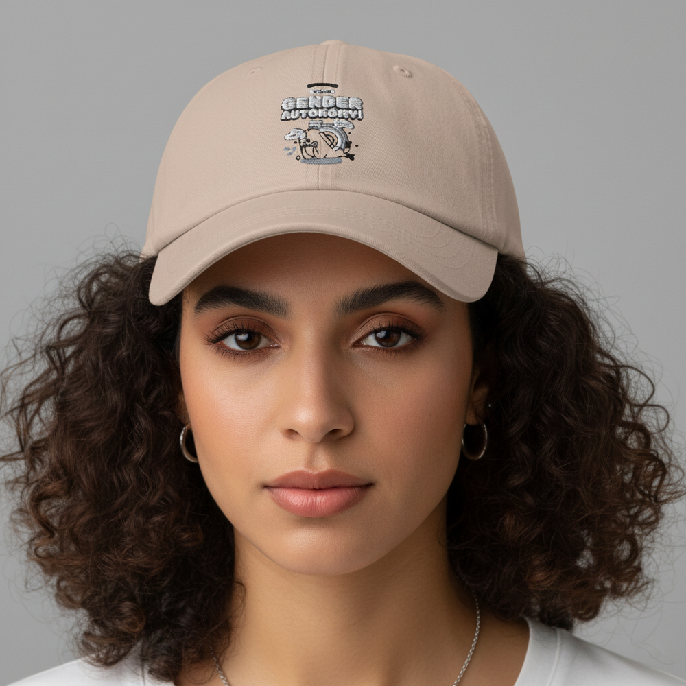 Front-facing model wearing a beige cap with embroidered text and cartoon graphic