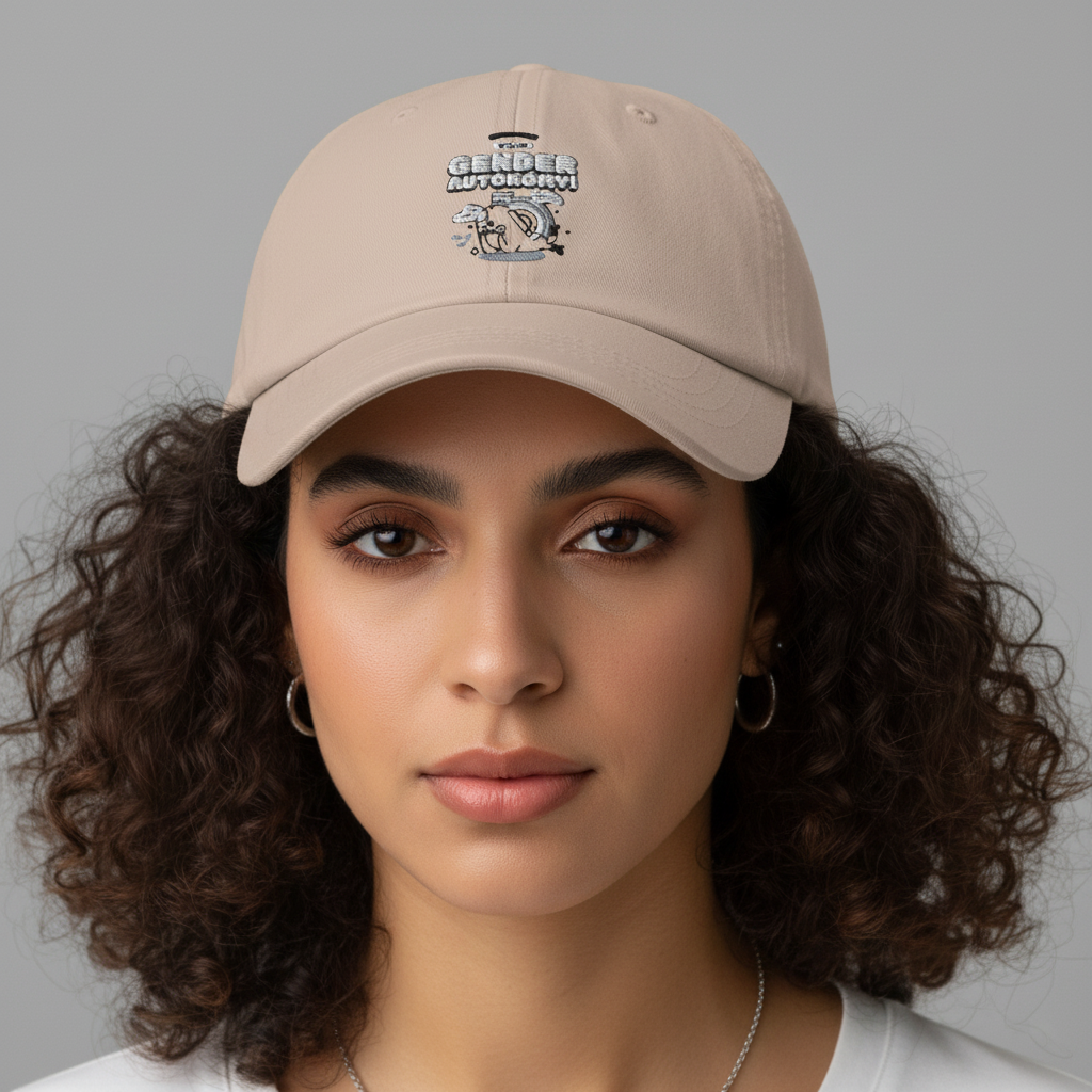 Front-facing model wearing a beige cap with embroidered text and cartoon graphic