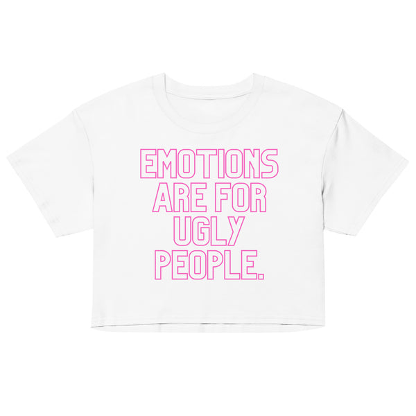 Front view of a white cropped T-shirt with pink text, “EMOTIONS ARE FOR UGLY PEOPLE.”