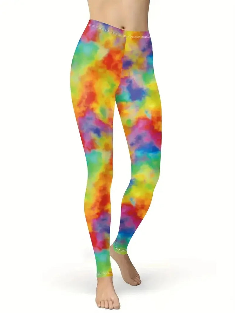 Rainbow tie-dye leggings with colorful cloud-like patches, shown on a model