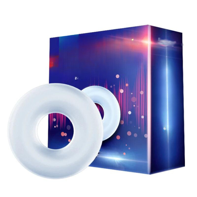 Two white silicone cock rings in front of a blue and purple product box