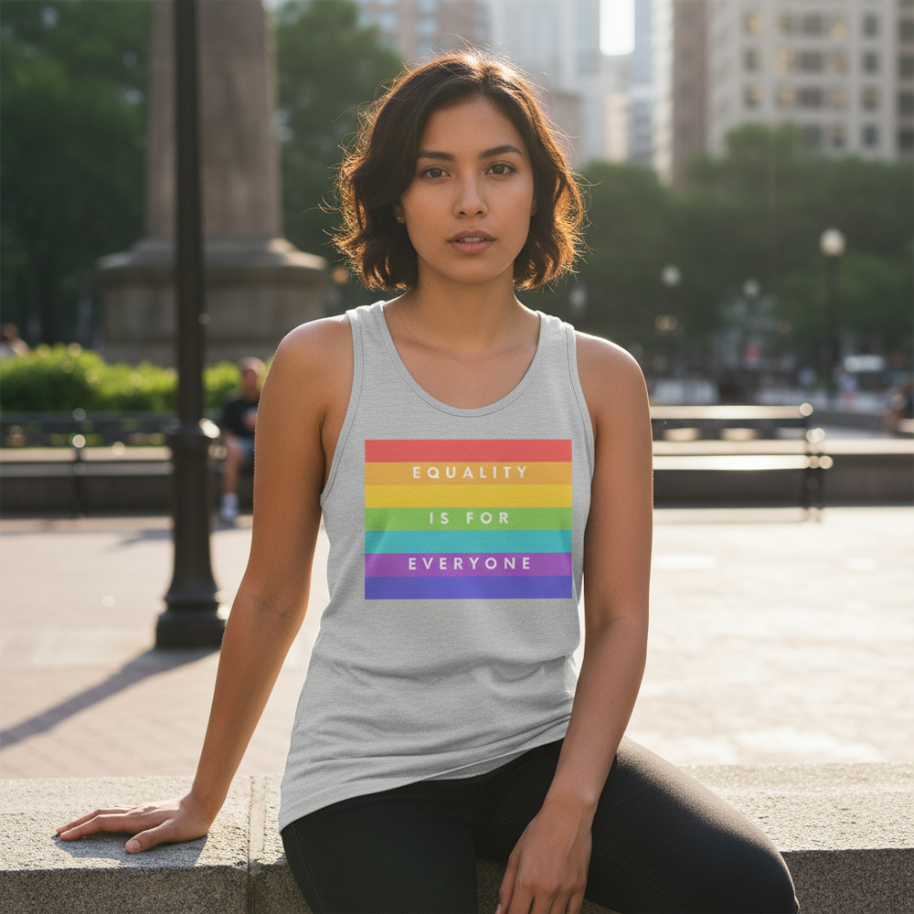 Gray unisex tank top with a rainbow Pride flag and "Equality Is For Everyone" in white, worn by a queer woman in a city park.