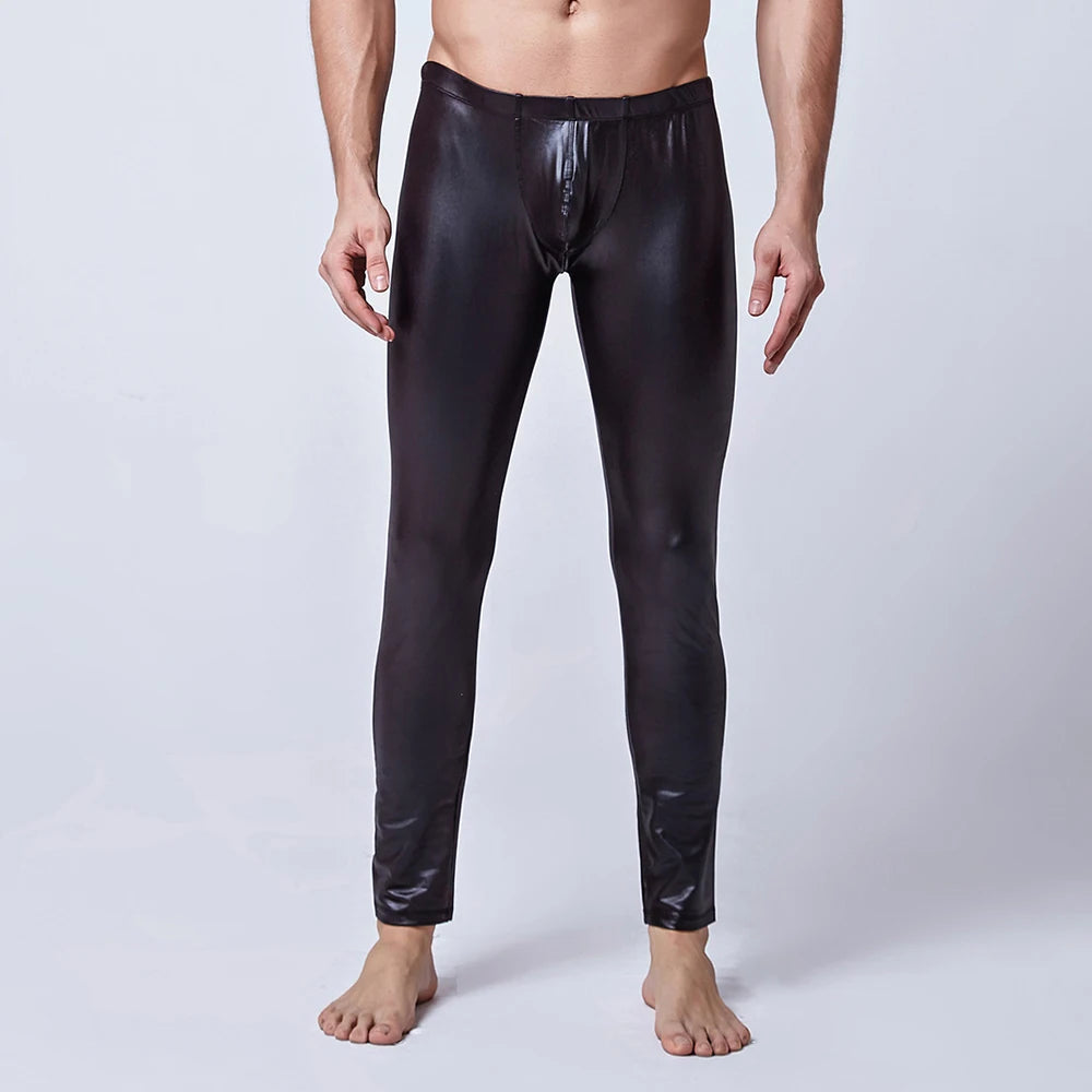 Front-view model wearing fitted black leather-look pants with a zip fly