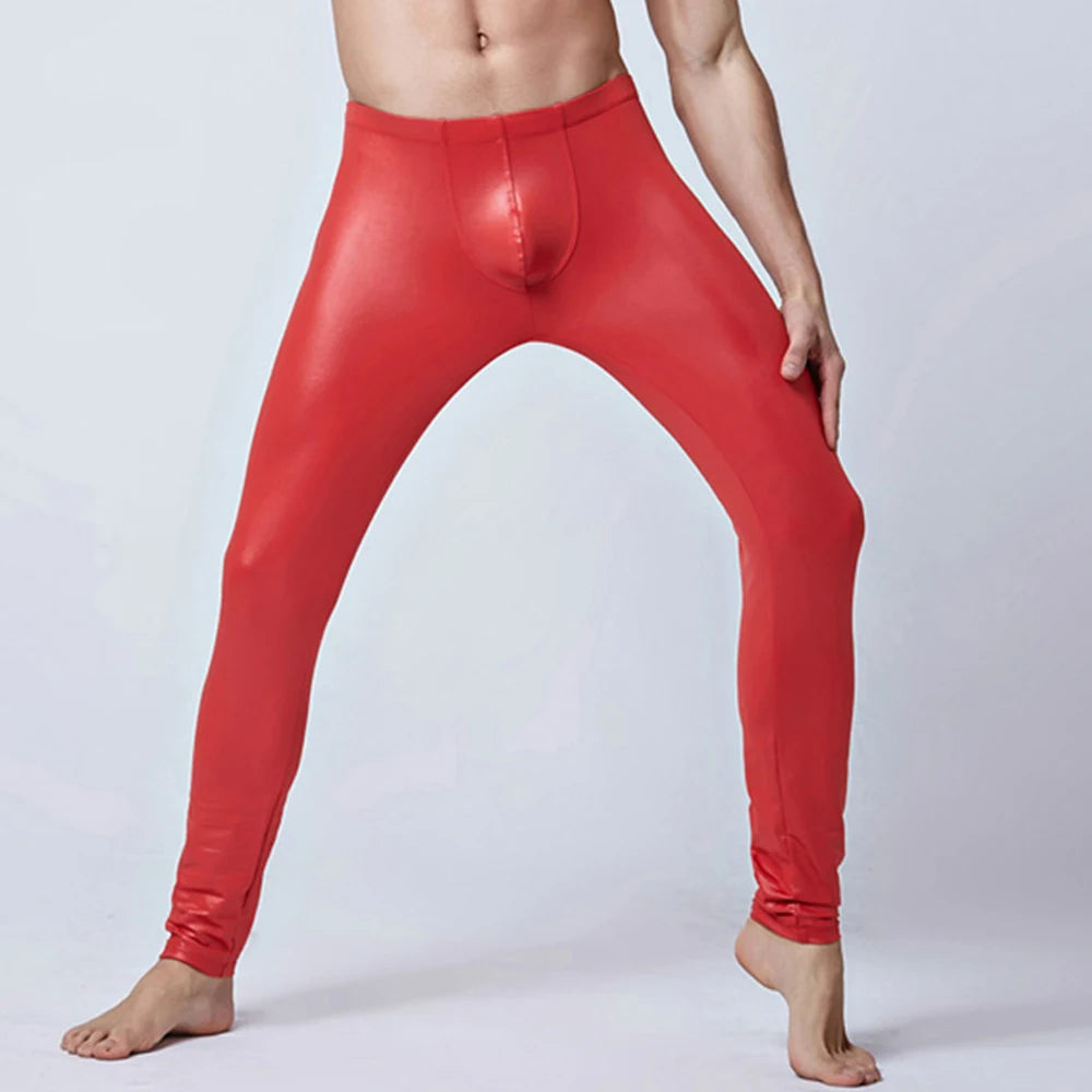 Front view of a shirtless model wearing shiny red skinny leather pants