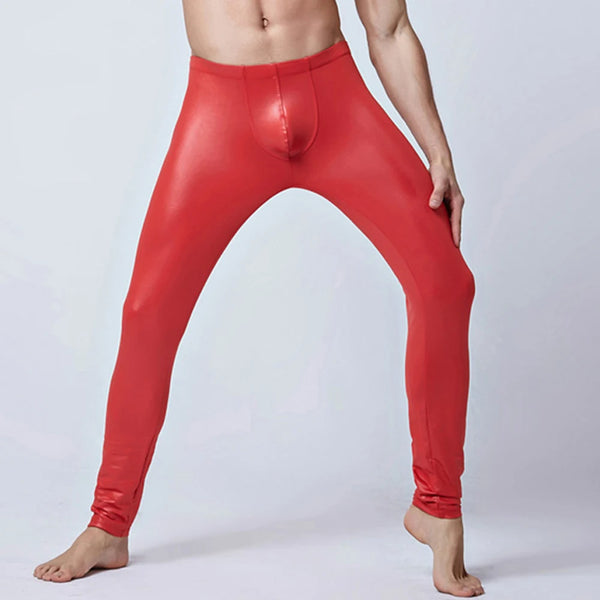 Front view of a shirtless model wearing shiny red skinny leather pants