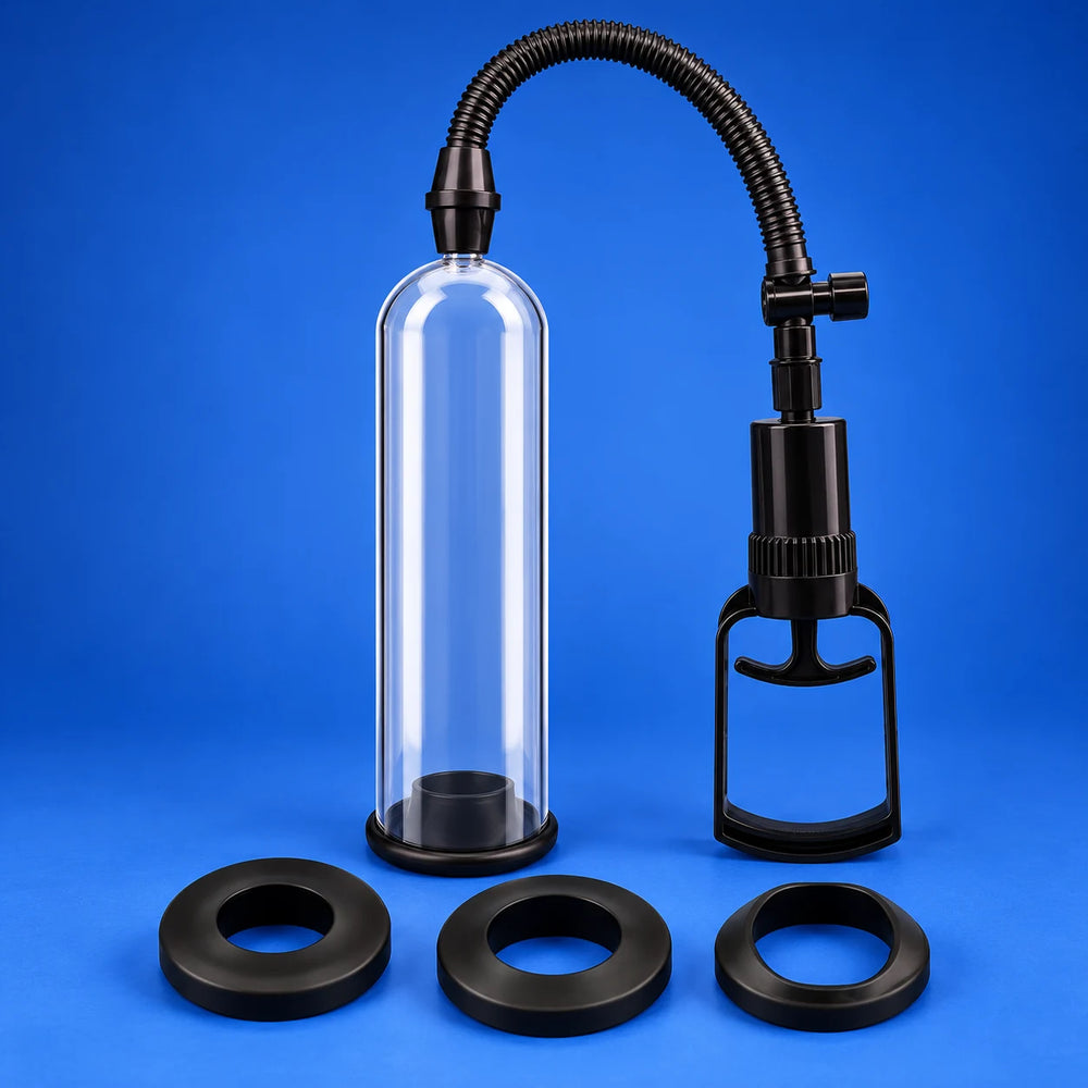 Clear Essential Trainer manual penis pump with black hand pump, ribbed hose and three sealing rings displayed against cobalt.