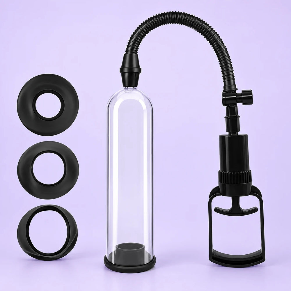 Essential Trainer manual penis pump with clear cylinder, black ribbed hose, hand pump and three sealing rings against lavender.