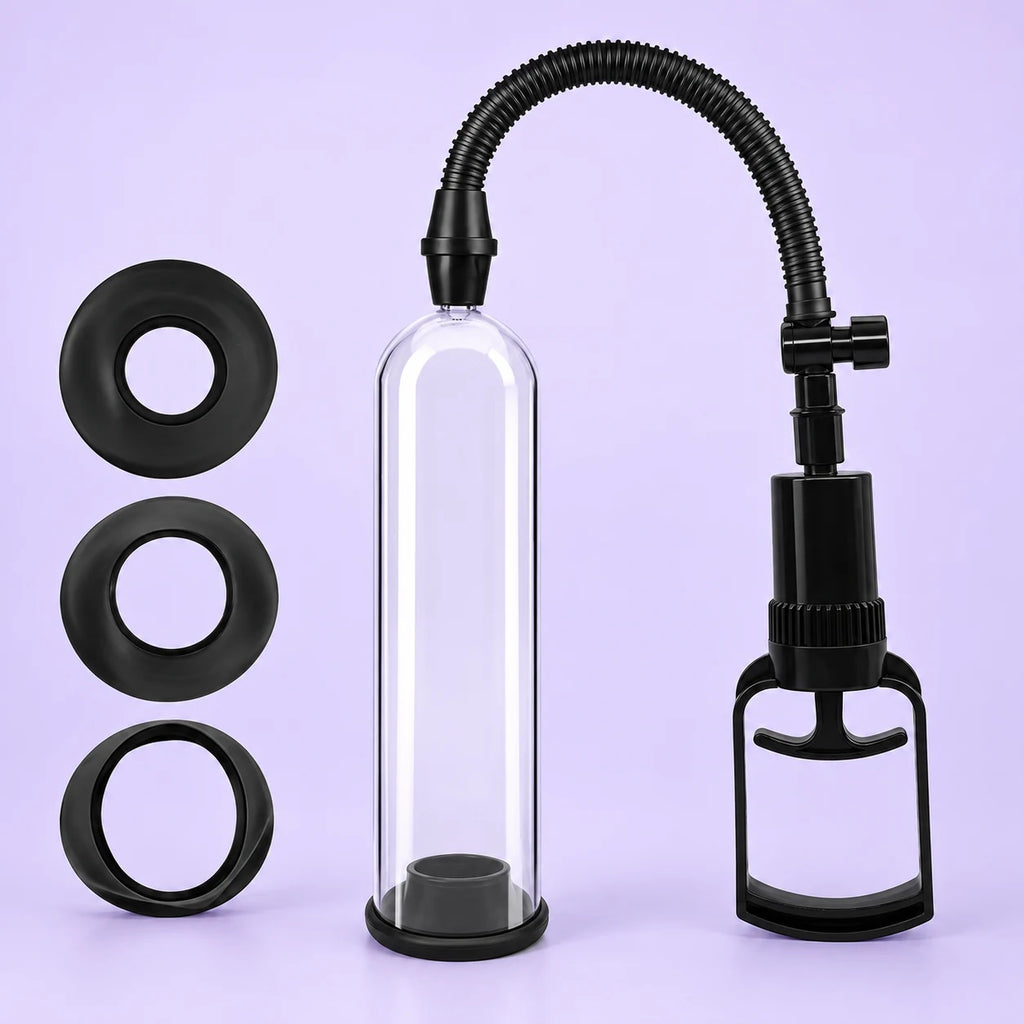 Essential Trainer manual penis pump with clear cylinder, black ribbed hose, hand pump and three sealing rings against lavender.