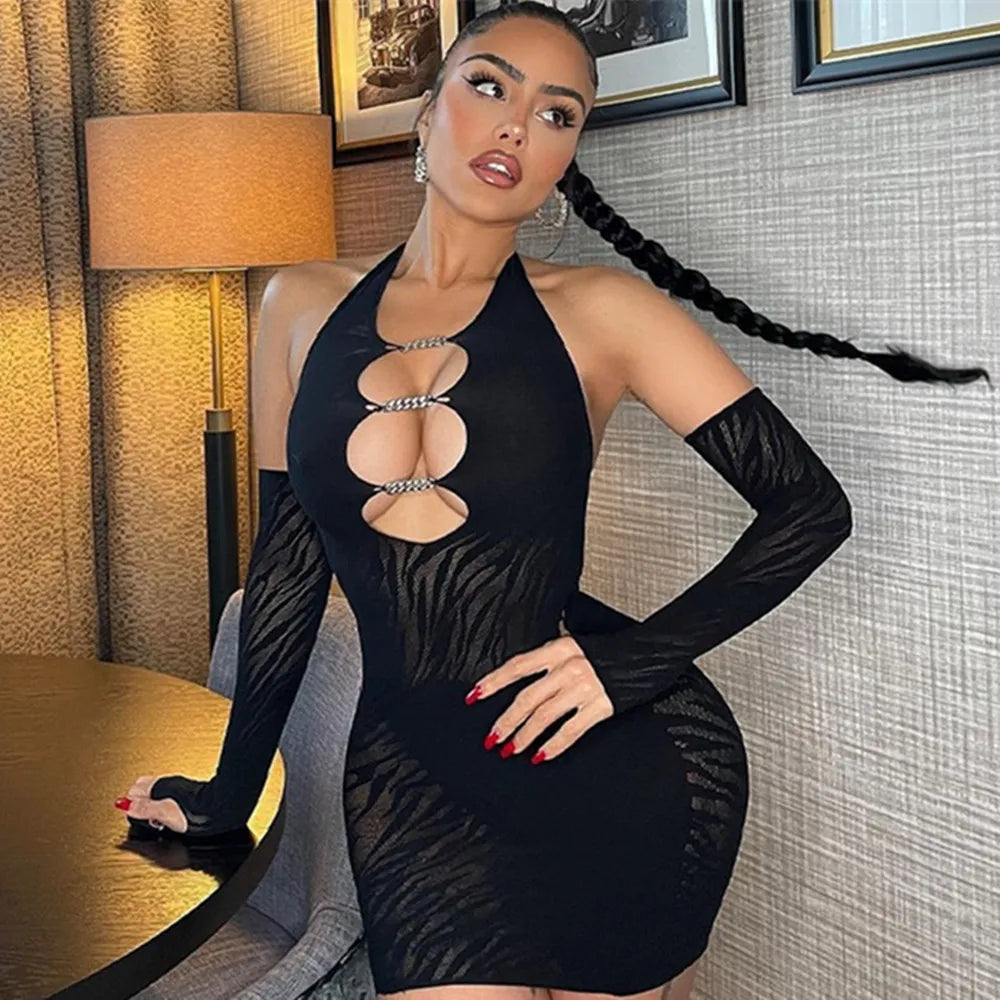 Model wearing a black cutout dress with sheer long sleeves and mesh panels