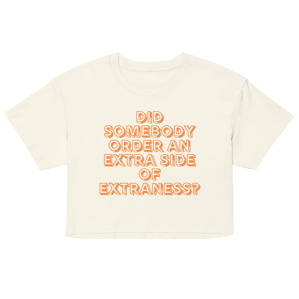 Front-facing cream gay crop top with orange text reading “DID SOMEBODY ORDER AN EXTRA SIDE OF EXTRANESS?”