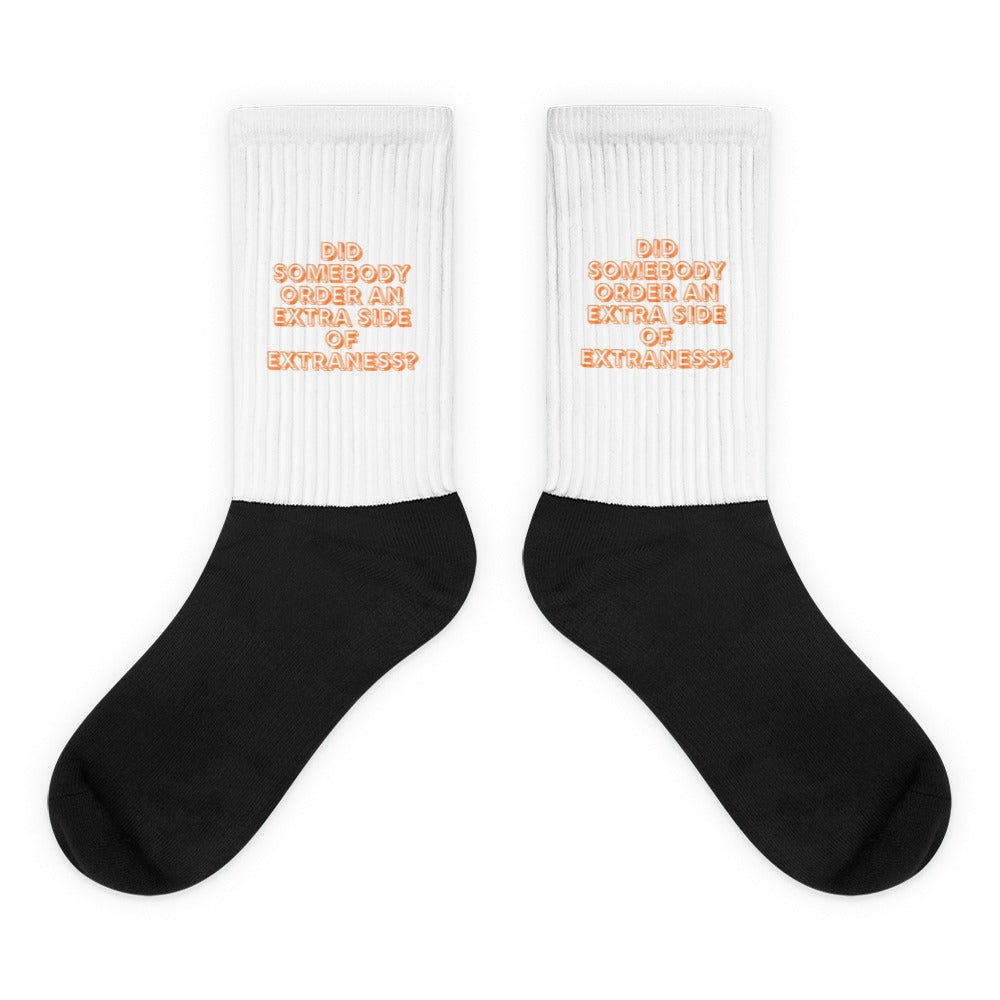 Pair of black-and-white crew socks with orange text reading “DID SOMEBODY ORDER AN EXTRA SIDE OF EXTRANESS?”
