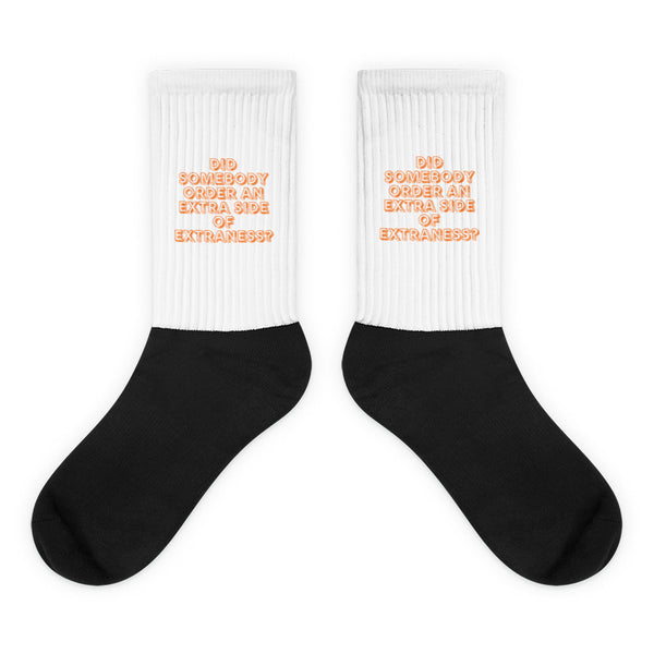 Pair of black-and-white crew socks with orange text reading “DID SOMEBODY ORDER AN EXTRA SIDE OF EXTRANESS?”