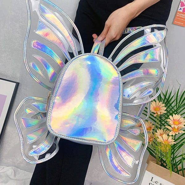 Iridescent butterfly-wing backpack held against a person in black clothing