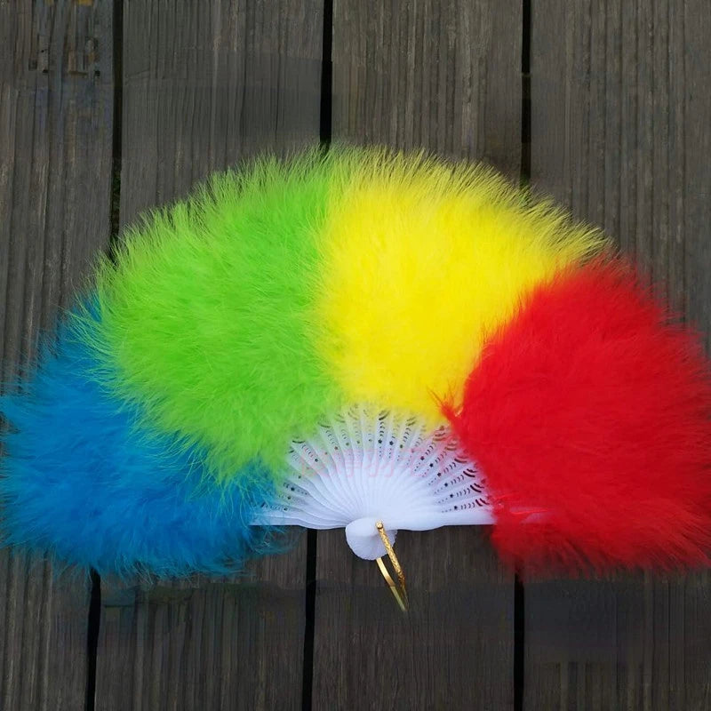 Open feather fan with blue, green, yellow, and red sections on a wooden background