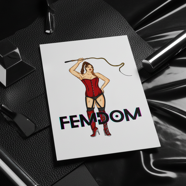 Angled postcard showing a person in a red corset holding a whip above “FEMDOM”