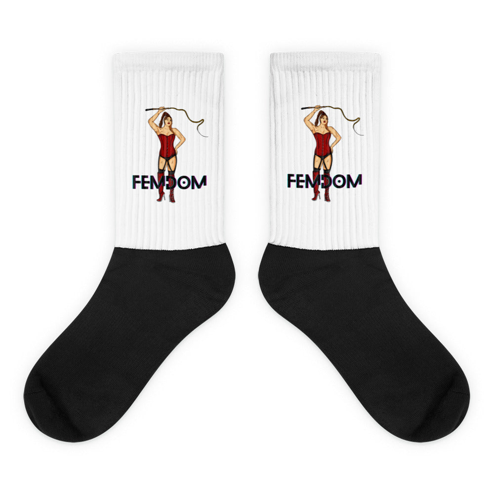 Pair of crew socks with white ribbed cuffs, black feet, and FEMDOM pin-up artwork