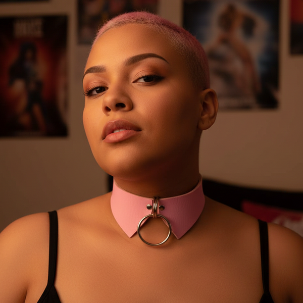 Close-up model wearing a pink pointed-collar choker with a large metal O-ring