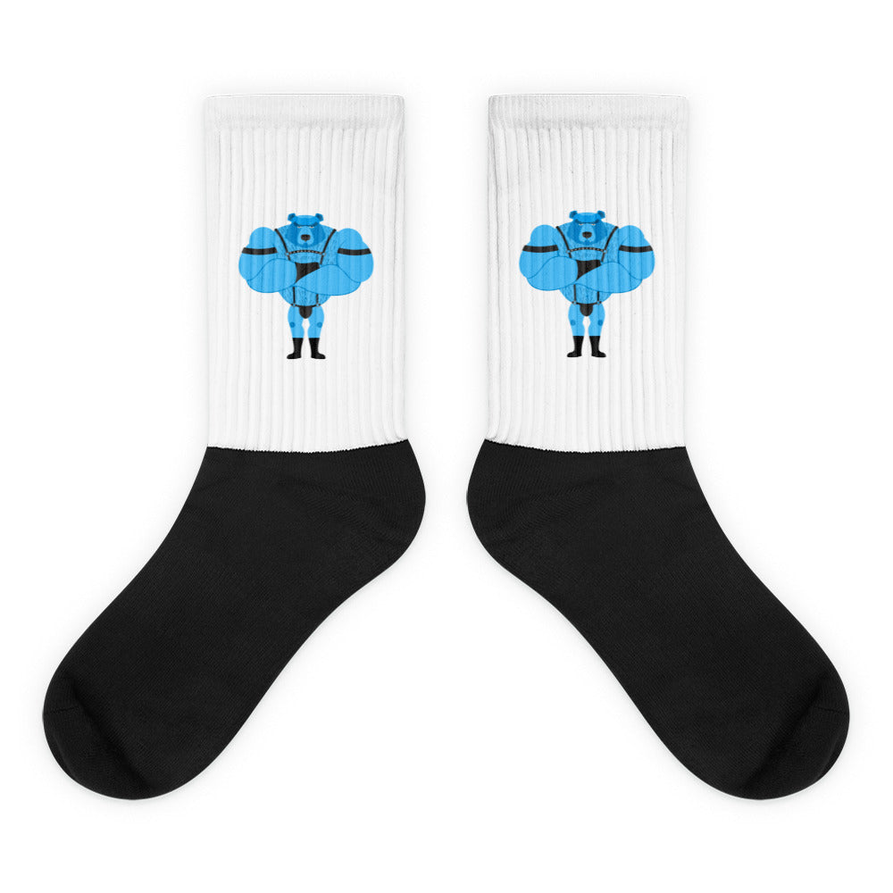 Pair of black-and-white crew socks with matching blue muscular figure designs