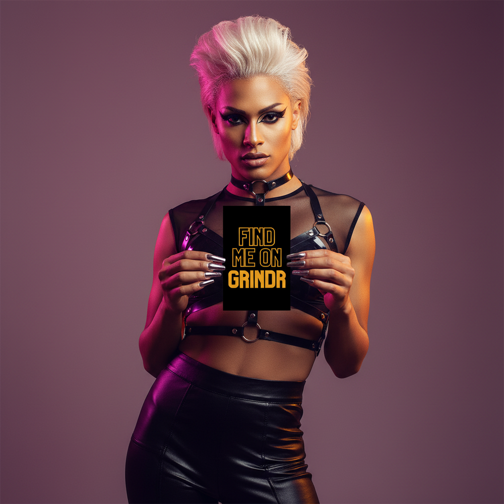 Queer postcard with a confident platinum-blond babe in a black harness and leather pants