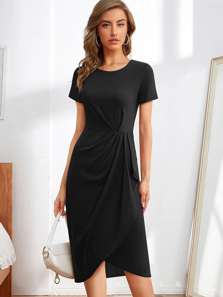 Model wearing a black short-sleeve dress with a twisted waist and draped skirt