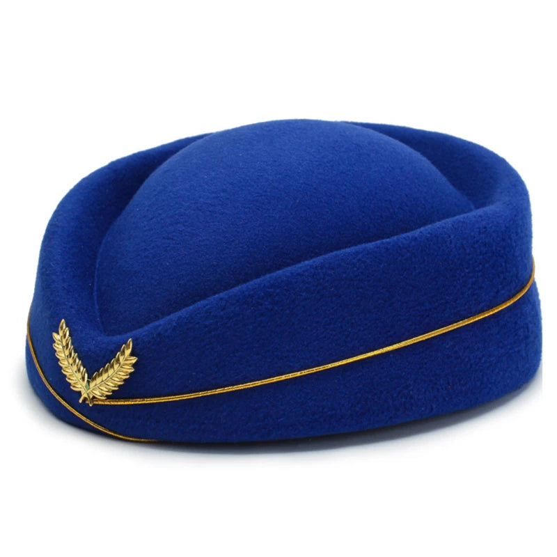 Royal blue felt pillbox-style hat with gold cord trim and laurel pin, shown at an angle