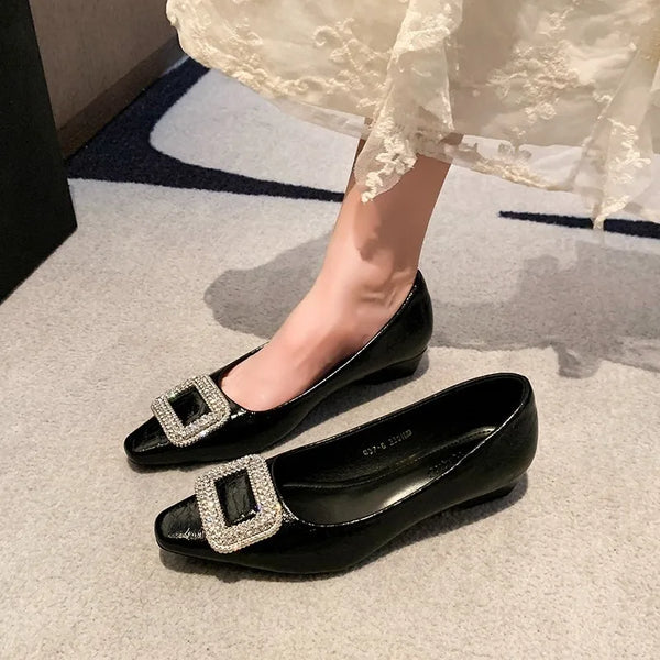 Black patent flats with rhinestone buckle details, one worn beneath a lace dress