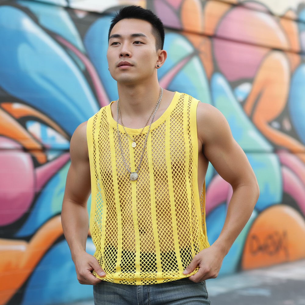 Model wearing a bright yellow sleeveless fishnet tank top in front of colorful graffiti