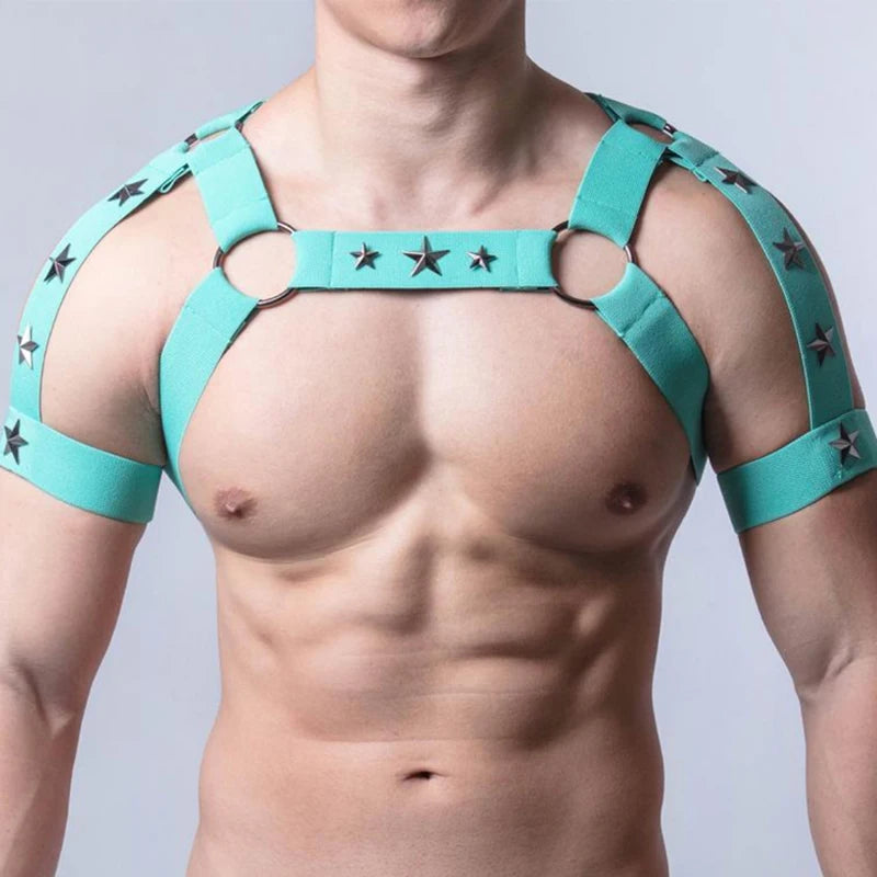 Front-facing shirtless model wearing a turquoise elastic chest harness with star studs and O-rings