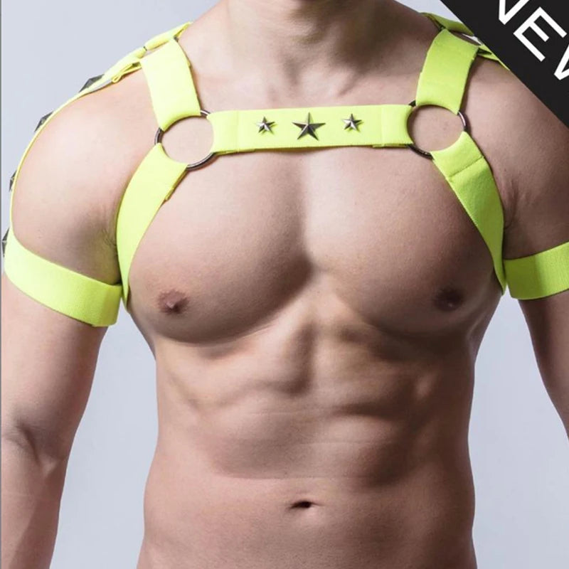 Close-up front view of a neon-yellow elastic chest harness with star studs on a bare torso