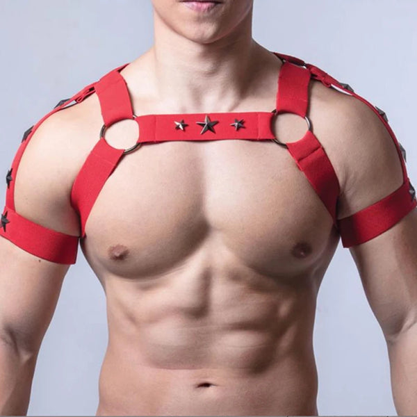 Cropped male torso wearing a red elastic harness with star studs and metal rings
