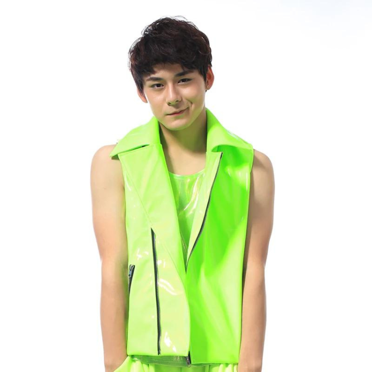 Front-facing model wearing a neon green glossy zippered vest over a matching top