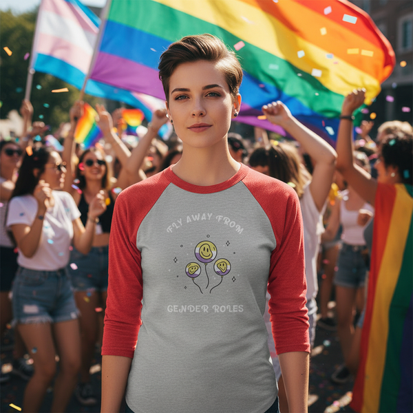 3/4 sleeve raglan shirt reads “Fly away from gender roles” with smiling balloons