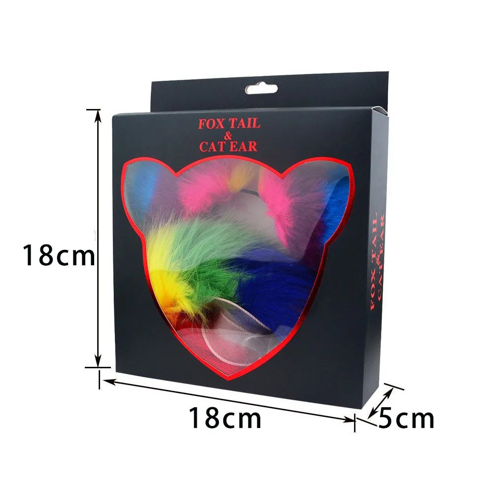 Boxed rainbow cat-ear headband and multicolored faux-fur tail, shown with 18 by 18 by 5 cm dimensions