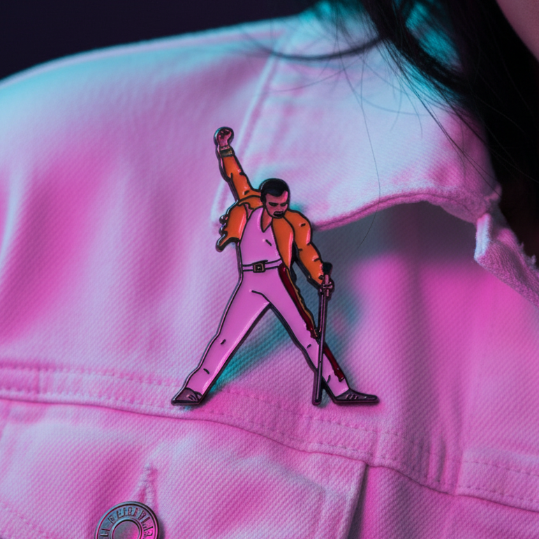 Freddie Mercury enamel pin showing a microphone pose on a pink jacket