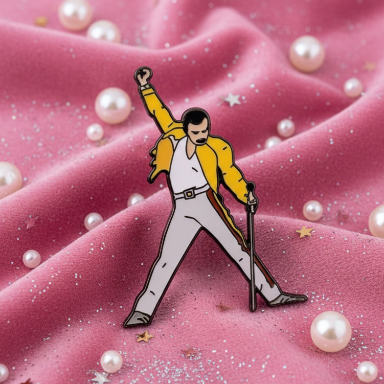 Freddie Mercury enamel pin depicting a singer in a yellow jacket and white jumpsuit