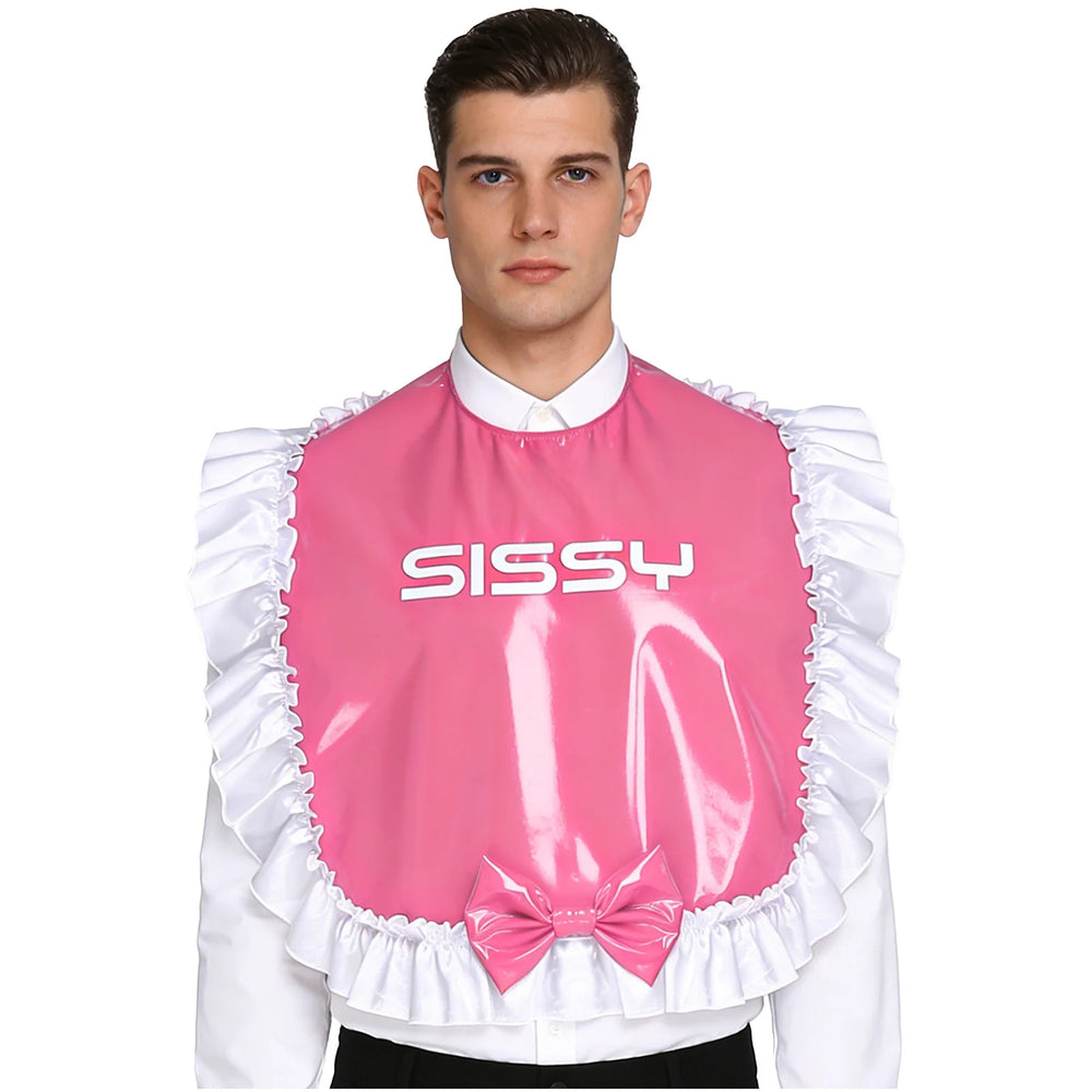 Front-facing model wearing a glossy pink bib with white ruffles, bow, and “SISSY” lettering