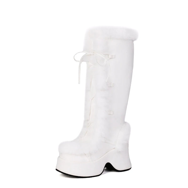 White knee-high platform boot with a rounded toe, tall heel, and lace-up front
