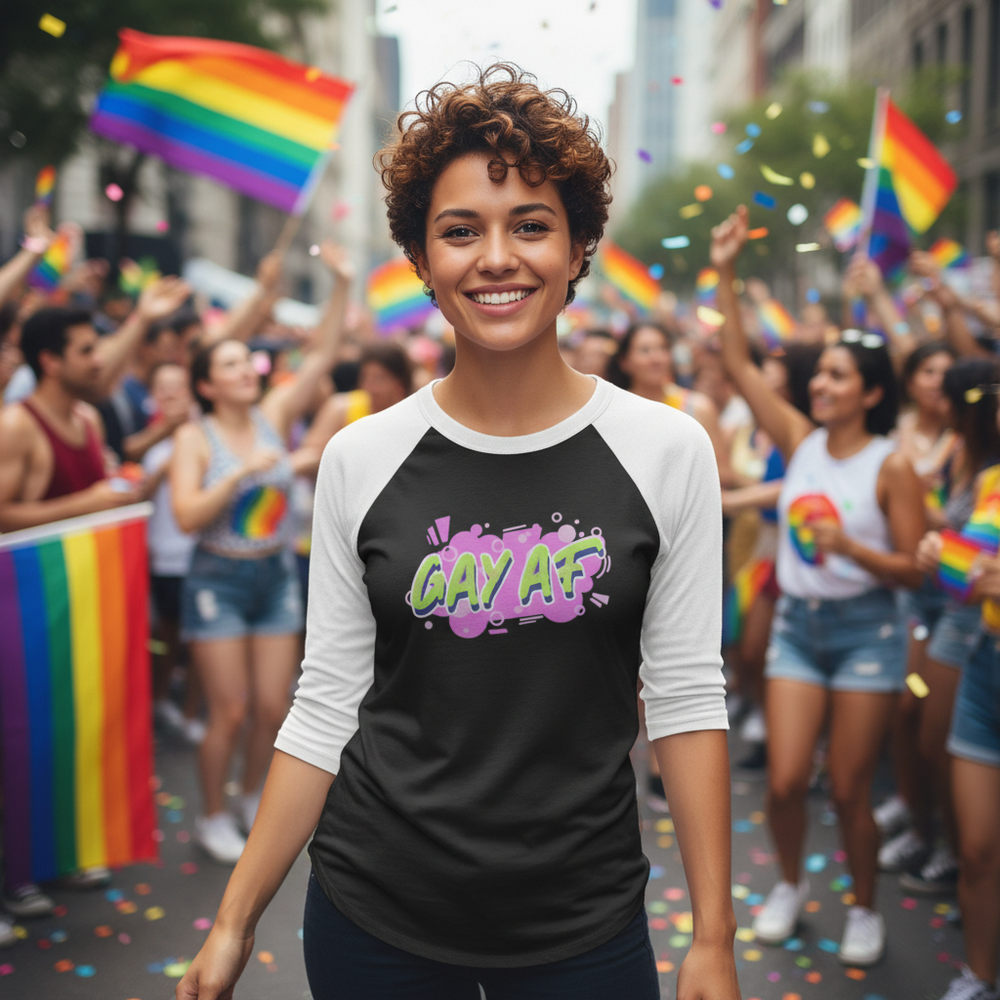 Gay AF 3/4 Sleeve Raglan Shirt worn by a smiling person with short curls at a pride parade
