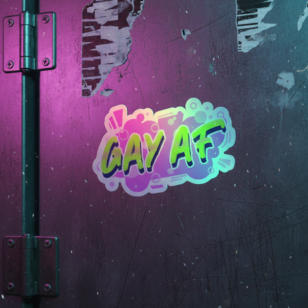 Gay AF holographic sticker brings rainbow queer vibes to a scratched metal wall, purple and teal lights, pipe left side.