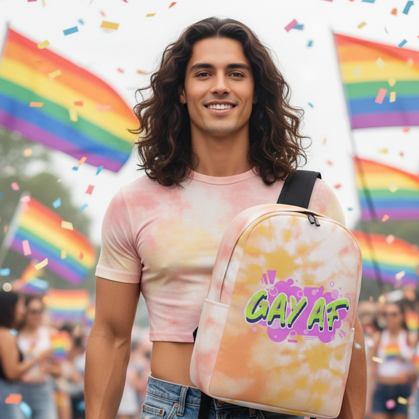 Person wearing a pastel tie-dye backpack labeled “GAY AF” at a Pride event