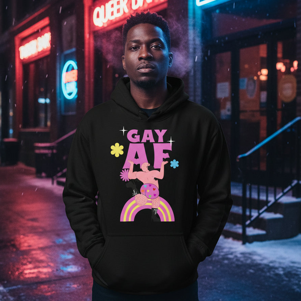 Person in a Gay AF Unisex Hoodie with bold makeup stands in front of a neon-lit club backdrop, embodying queer pride, visibility, and self-expression.