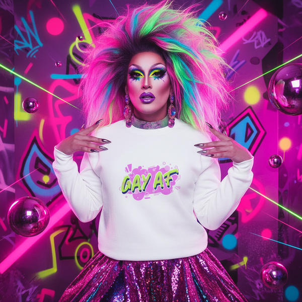 Drag performer in a rainbow wig wearing a white “GAY AF” sweatshirt and sequined skirt