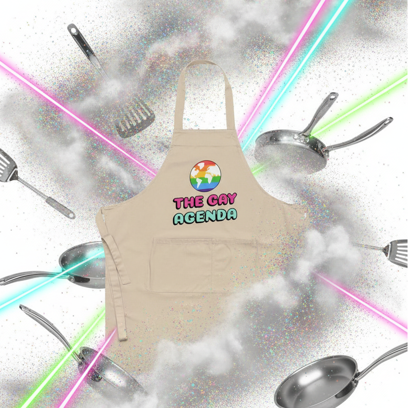 Beige apron with rainbow globe and “THE GAY AGENDA” text, surrounded by cookware and neon beams