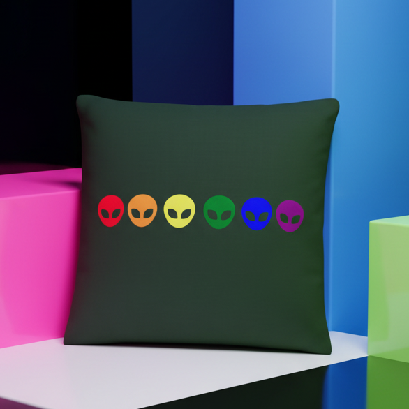 Dark square cushion with six colorful alien faces in a row