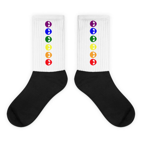Pair of black-and-white crew socks with vertical rainbow alien-face icons