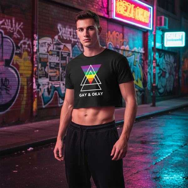 Model wearing a black cropped T-shirt with a rainbow triangle graphic and “GAY & OKAY” text