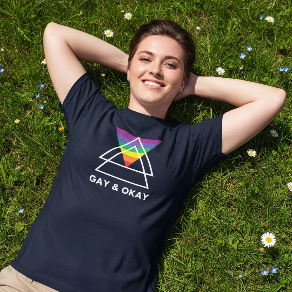 Gay & OK T-shirt with bold “GAY & OKAY” text, rainbow and purple flag, white geometric shapes