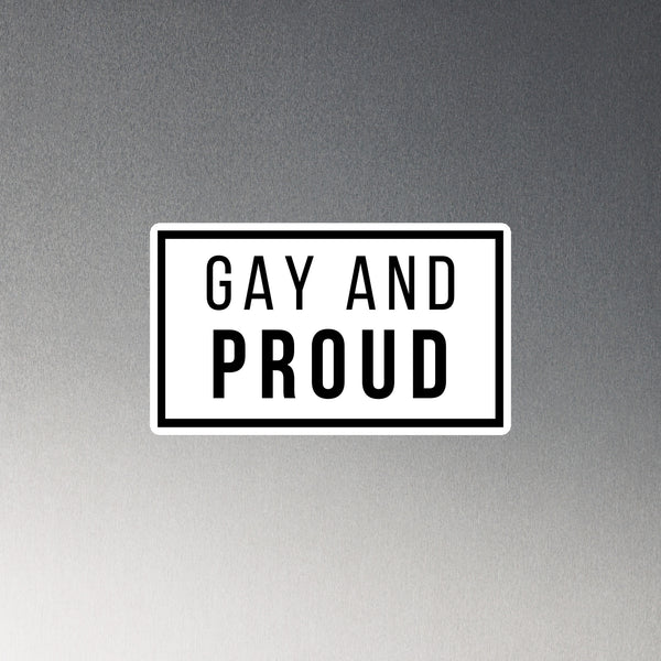 Rectangular white magnet with a black border and the words “GAY AND PROUD” in bold black letters